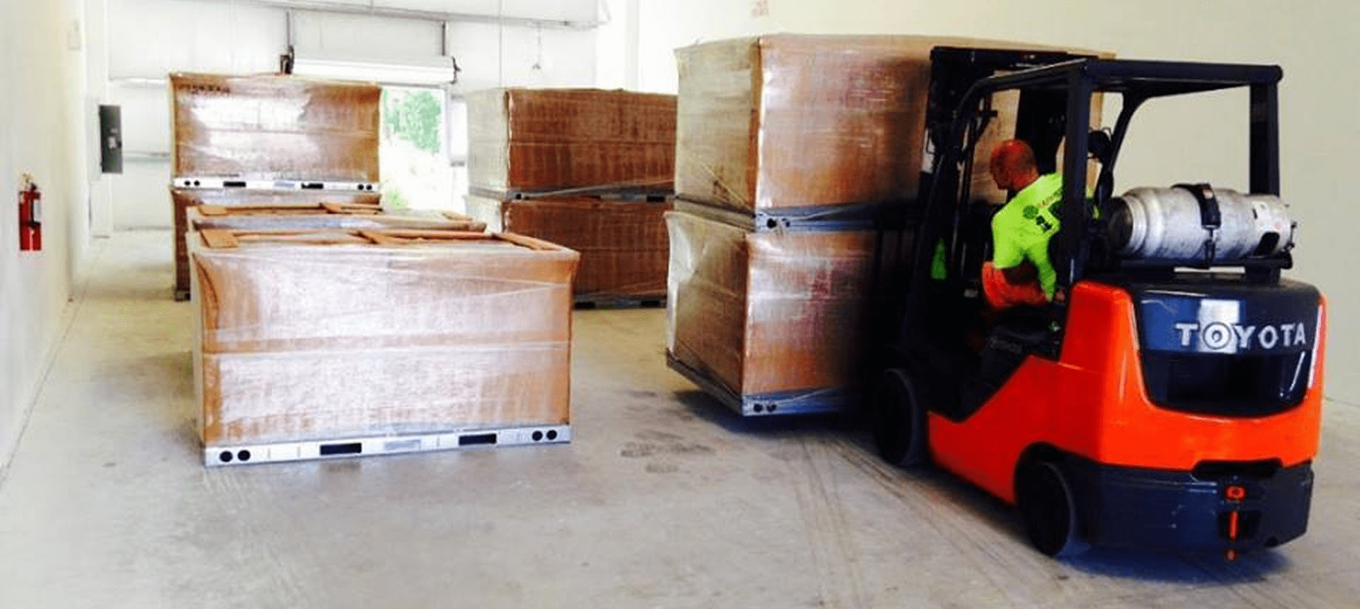 Forklift moving pallets in warehouse