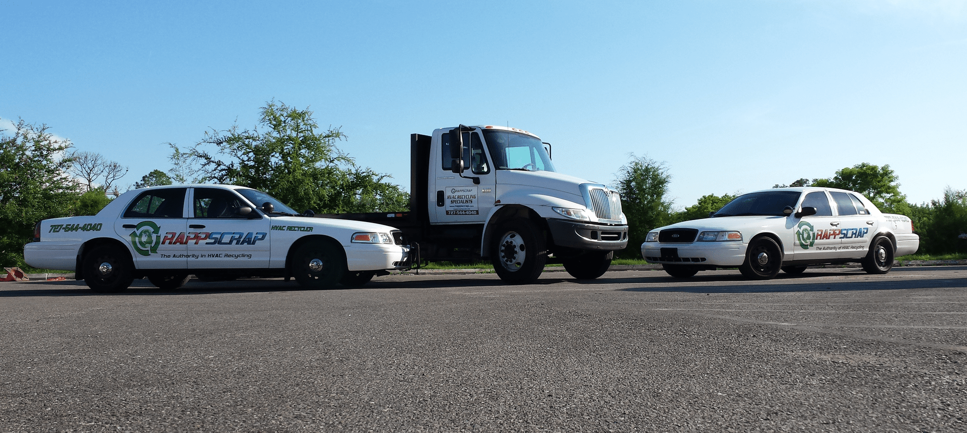 Three vehicles on an empty road