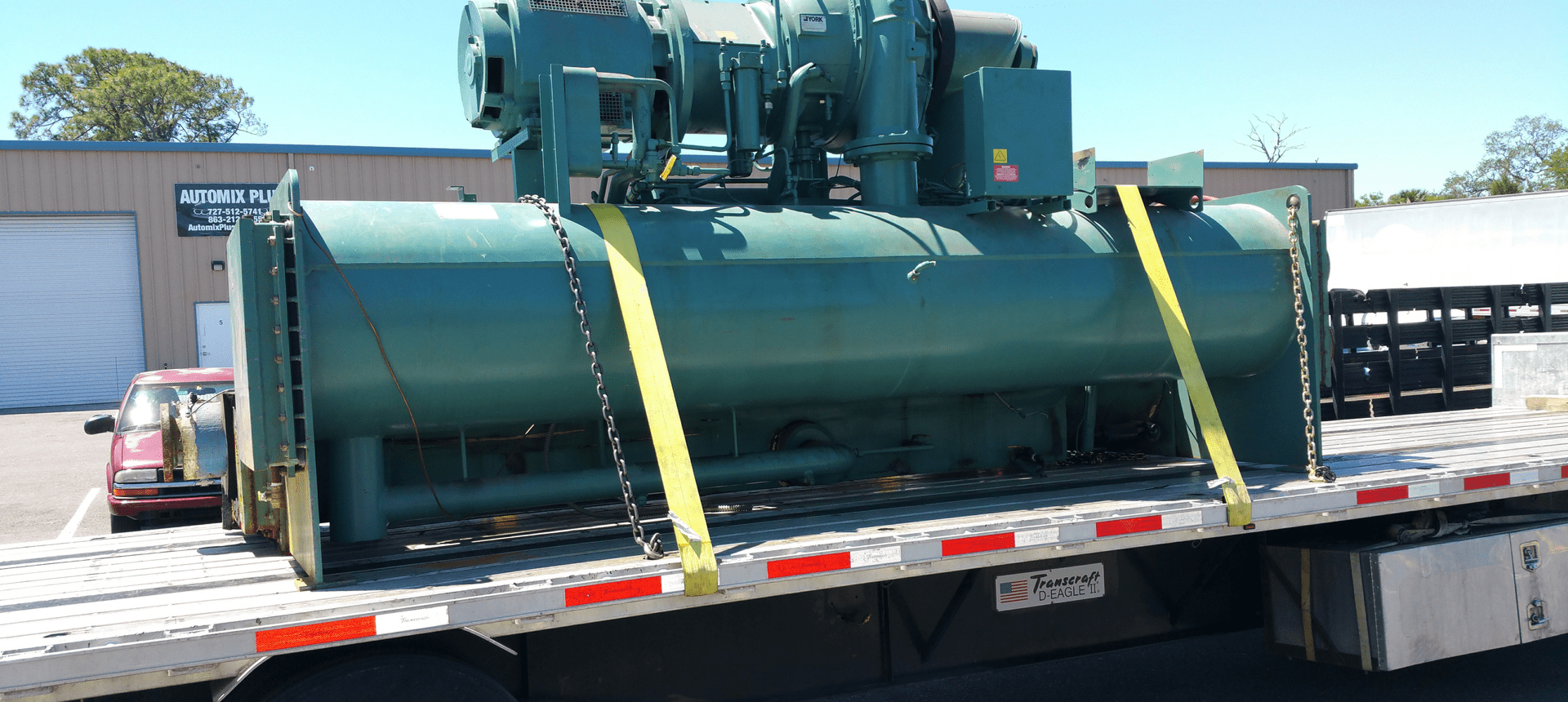 Heavy-duty machine strapped for transport